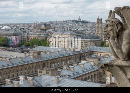 Notre Dame Cathedral gargoyle overlooks Paris, France Stock Photo