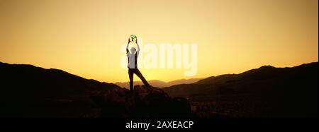 Silhouette Of A Man Holding A Globe, Nevada, USA Stock Photo