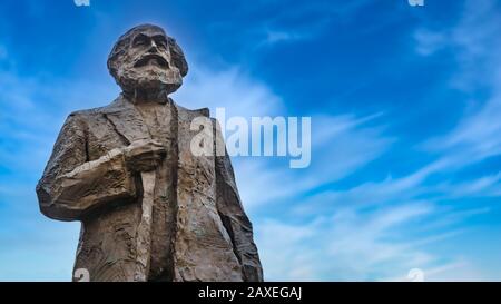 Statue of famous communist Karl Marx in Trier, Germany with blue sky Stock Photo