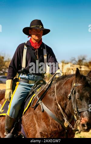 Renactor dressed in the uniform of the 1880s US Army soldier in the 5th Cavalry on horseback at Fort Lowell, Tucson AZ Stock Photo