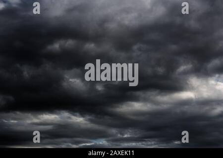 Abundant black clouds cover the sky announcing the storm. Stock Photo