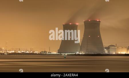 Riverbank with nuclear power plant Doel at night,  Port of Antwerp, Belgium Stock Photo