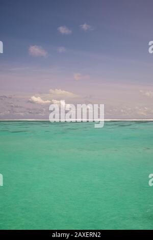 A portrait background photo of the sea and the sky in an idyllic island paradise Stock Photo