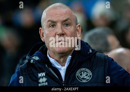 Swansea, UK. 11th Feb, 2020. Queens Park Rangers manager Mark Warburton looks on from the dugout. EFL Skybet championship match, Swansea city v Queens Park Rangers at the Liberty Stadium in Swansea, South Wales on Tuesday 11th February 2020. this image may only be used for Editorial purposes. Editorial use only, license required for commercial use. No use in betting, games or a single club/league/player publications. pic by Lewis Mitchell/Andrew Orchard sports photography/Alamy Live news Credit: Andrew Orchard sports photography/Alamy Live News Stock Photo