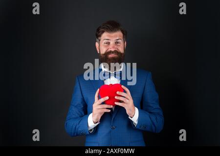 You should try it. businessman with bow tie. problems with heart. Romantic greeting. happy valentines day. tuxedo man red heart. love date. mature hipster beard in formal suit. problems with heart. Stock Photo