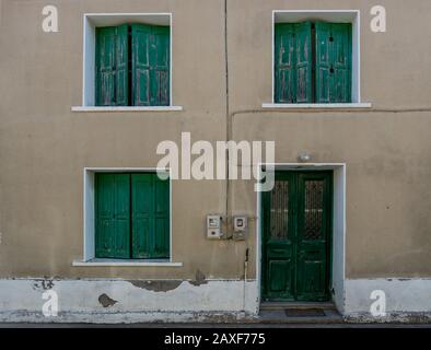 Traditional Greek building with green shutters and door in the village of Skala Eressos in Lesvos Greece Stock Photo
