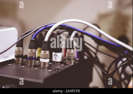 Closeup shot of plugged-in electronic cables on a blurred background Stock Photo