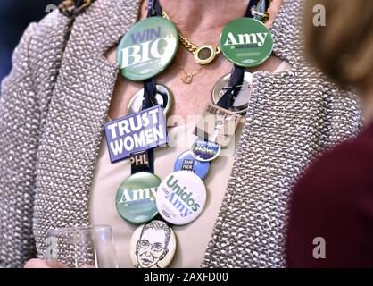 Concord, United States. 11th Feb, 2020. A supporter of Democratic presidential candidate for 2020 and Minnesota Sen. Amy Klobuchar wears campaign buttons during a New Hampshire 2020 presidential primary night event at the Grappone Center in Concord, New Hampshire on Tuesday, February 11, 2020. Klobuchar was hoping for a strong showing in the first in the nation presidential primary. Photo by Joshua Reynolds/UPI Credit: UPI/Alamy Live News Stock Photo