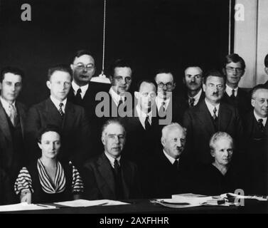 1933 , october , Bruxelles , BELGIUM : Physicists at the Seventh Solvay Physics Conference . In this image, which includes in the front row (at left) Irene Joliot Curie (1897-1956) and (at right) her mother Marie Sklodowska Curie (1867-1934), and in back row (left) her husband Frederic Joliot (1900-1958), is part of a photograph taken of all attendees. Nearly every major scientist interested in research relating to atomic physics attended that meeting. In the front row are Irene Curie, Niels Henrik David Bohr (1885-1962), Abram Fedorovich Ioffe (1880-1960), and Marie Curie ; in the back row (f Stock Photo