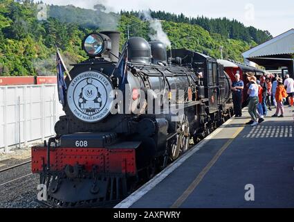 Picton, New Zealand - February 07, 2020: Passengers board the Marlborough Flyer Tourist Steam Train at Picton Station. Stock Photo