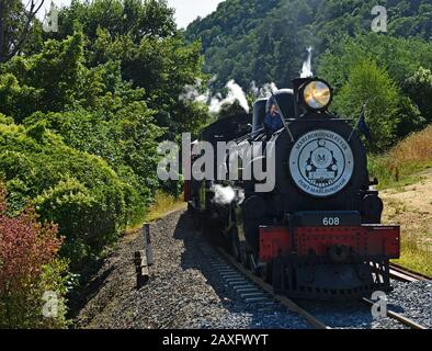 Picton, New Zealand - February 07, 2020: Marlborough Flyer Tourist Steam Train climbs a steep hill out of Picton. Stock Photo