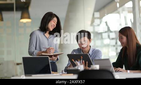 Group of professional UI application developer working on their project with positive attitude Stock Photo