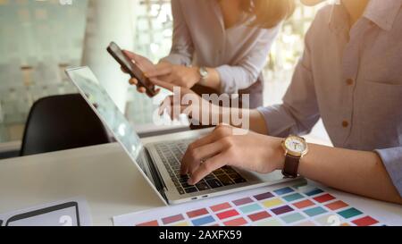 Cropped shot of young UI designer working on his project while typing on laptop computer Stock Photo