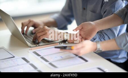 Cropped shot of young UI designer working on his project while typing on laptop computer Stock Photo