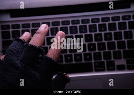 hacker hand stealing data from laptop, close up  Stock Photo