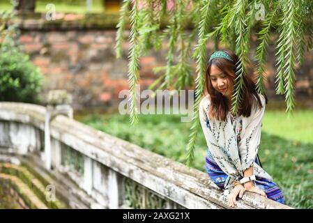 Vietnamese woman in the temple's garden Stock Photo