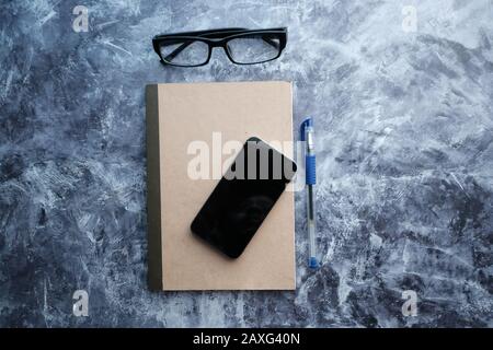 top view of smart phone , notepad and eyeglass  Stock Photo