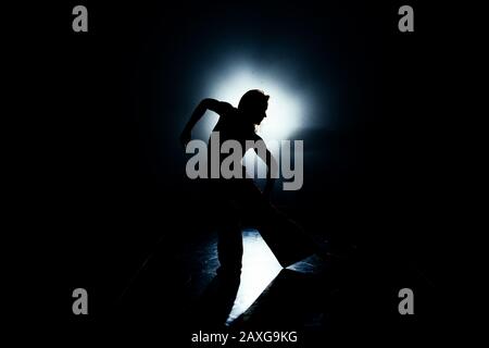Artistic modern dancer practicing dancing moves in the studio Stock Photo
