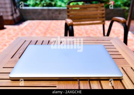 Close-up of laptop with closed lid on wooden table Stock Photo