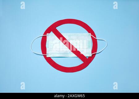 medical masks with red stop sign on blue background. Wuhan Stop virus, top view. Stock Photo