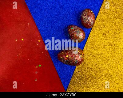 golden red easter eggs, with acrylic painted, over multicolored festive background. Happy Easter celebration. Holiday element. Spring symbol Stock Photo