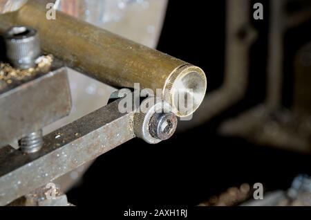 Straight knurling wheel being used in a lathe. Stock Photo