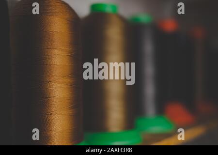 Selective focus of sewing thread. Some sewing threads have packaging on ...