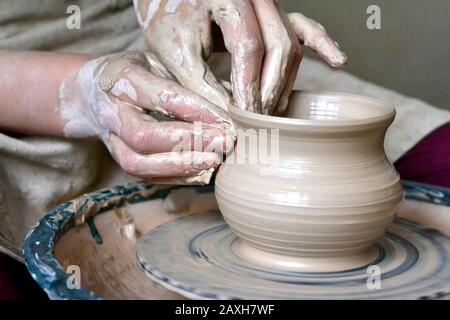 potter making vase from clay. Hands close-up master Stock Photo