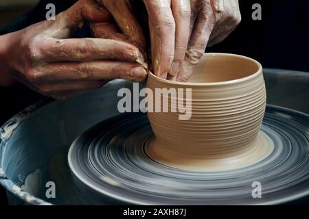 Master class on modeling of clay on a potter's wheel In the pottery workshop Stock Photo