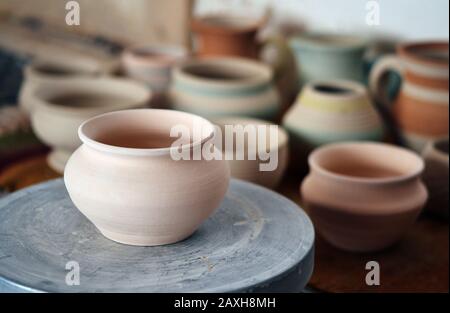 many clay pot is on the table in pottery. Copy spase Stock Photo