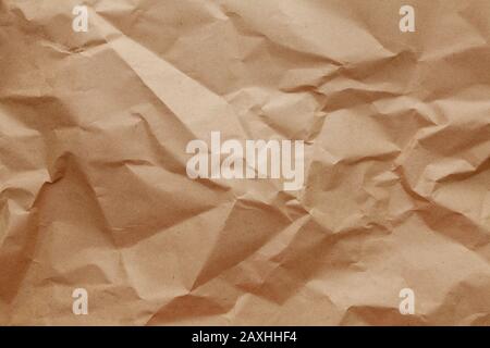 Textured crumpled packaging a brown paper background. Stock Photo