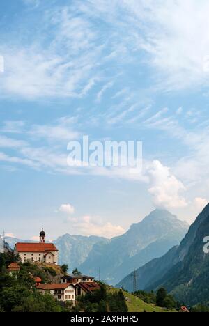 St Gallus Church and mountain valley landscape of Wassen in the Swiss canton of Uri in the Swiss Alps, Switzerland EU Stock Photo