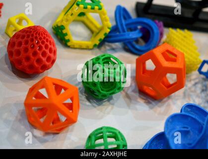 Objects printed by 3d printer. Bright colorful objects printed on a 3d printer on a table Stock Photo
