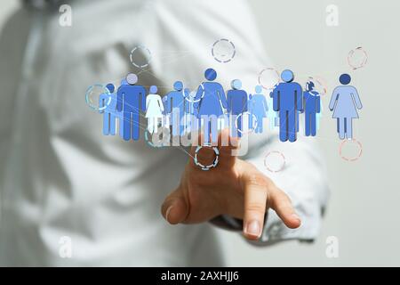 Human hand presenting the digital projection of people network Stock Photo