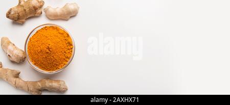 Turmeric roots with turmeric powder isolated on white Stock Photo