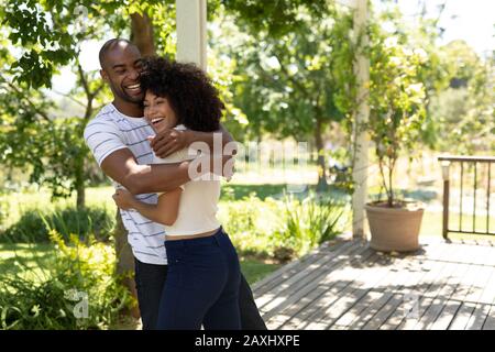 Happy young couple smiling and hugging each other Stock Photo