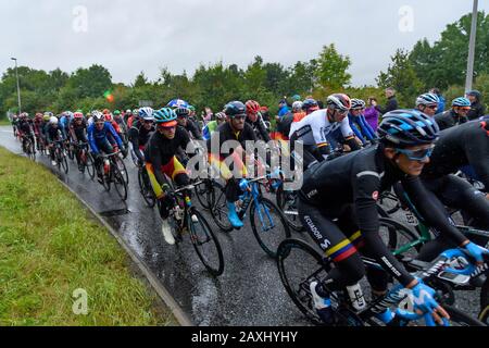 Men road cycle racing (cyclists on bikes in peloton) riding & competing in race watched by supporters in rain - UCI World Championships, Yorkshire, UK Stock Photo