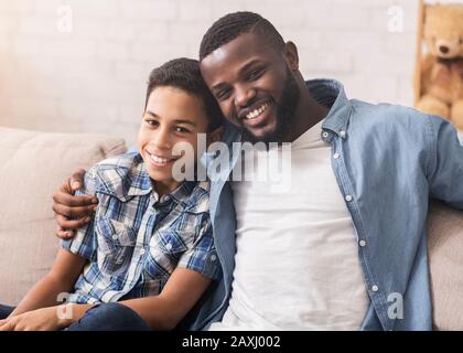 Happy african american father and son taking selfie at home Stock Photo