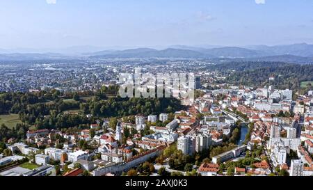 Ljubljana aerial view is Slovenia's capital and largest city. Flying over famous Ljubljana Castle feat old town square and buildings in Central Europe Stock Photo
