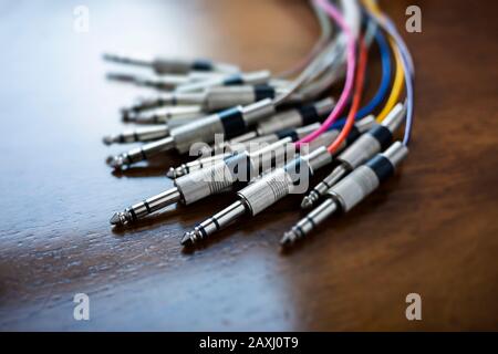 Close up of a bunch of audio jack plugs with colourful cables, selective focus and narrow depth of field Stock Photo