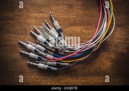 Bundle of audio jack plugs with colourful cables with a focus vignette Stock Photo