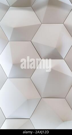 3D decorative wall for the interior of an unusual hexagonal geometric shape similar to honeycombs. White light background with a pattern imitating a t Stock Photo