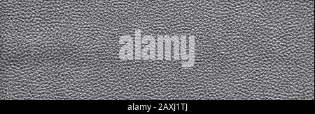Dark gray abstract rough decorative texture imitating leather. Textured paper with copy space. Graphite color paper surface, texture closeup. Stock Photo