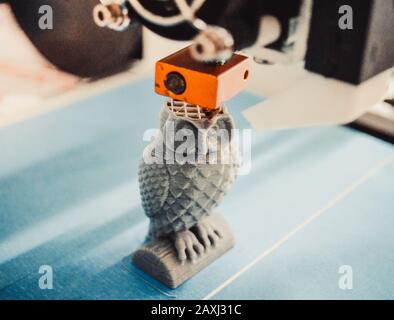 HD 1080 3D printer prints, creates, pouring, yellow a figure, shape of plastic, close-up. 3D printer prints red shapes on a red background Stock Photo