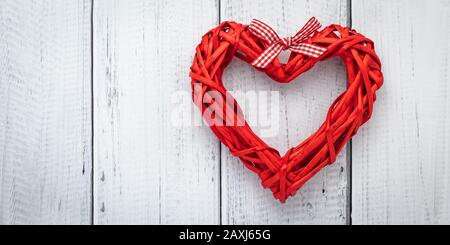 Red heart from ribbon on white wooden background, template with text space. Flat lay with love concept, valentine card, mockup. Layout decoration. Fes Stock Photo