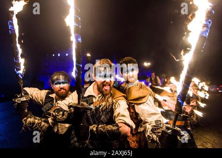 Set on the Edinburgh Castle(washed in blue)esplanade, an eclectic selection of PyroCelticaand Harbinger Drum Crewperformers in full HighlandWarrior costume will showcase adazzling array of fire skills featuring fire fans, huge flaming claymoresand fire staffs, set to the booming beats of the Harbinger Drummerscomplete with flaming drums and mohawk.  Credit: Euan CherrySet on the Edinburgh Castle(washed in blue)esplanade, an eclectic selection of PyroCelticaand Harbinger Drum Crewperformers in full HighlandWarrior costume will showcase adazzling array of fire skills featuring fire fans, huge fl Stock Photo