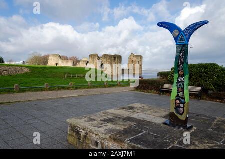 Flint, UK: Feb 11, 2020: An unusually high spring tide in the aftermath of storm Ciara sees the River Dee reach the walls of the castle. On the right Stock Photo