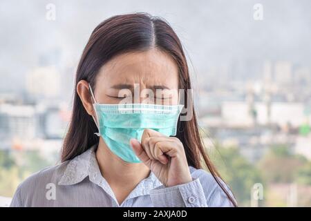 PM2.5. people feeling sick from air pollution, environment has harmful or poisonous effects. woman in the city wearing face mask to protect herself be Stock Photo