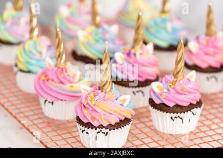 Step by step. Scooping batter with a cupcake scoop to make unicorn  chocolate cupcakes with buttercream frosting Stock Photo - Alamy