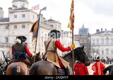 Mounted members of the English Civil War Society in historical costume, lead the parade to commemorate the execution of King Charles I Stock Photo